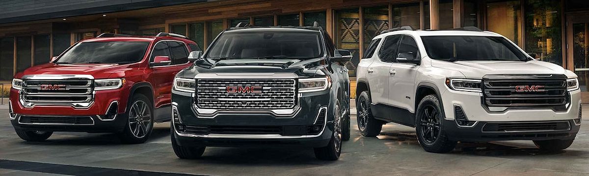 Lineup of New GMC Acadia Trims Parked in Front of House